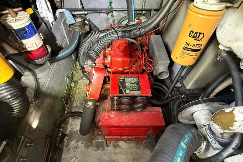 Slide: The Image of Engine compartment of a 1990 Sea Ray 420 Sundancer with visible components and wiring. - 33