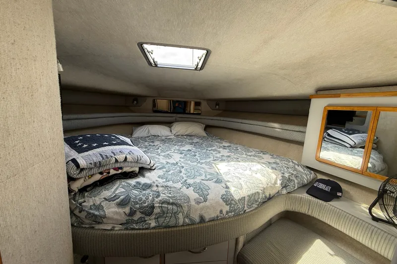 Slide: The Image of Cozy cabin interior of 1990 Sea Ray 420 Sundancer with bed, mirror, and skylight. - 21