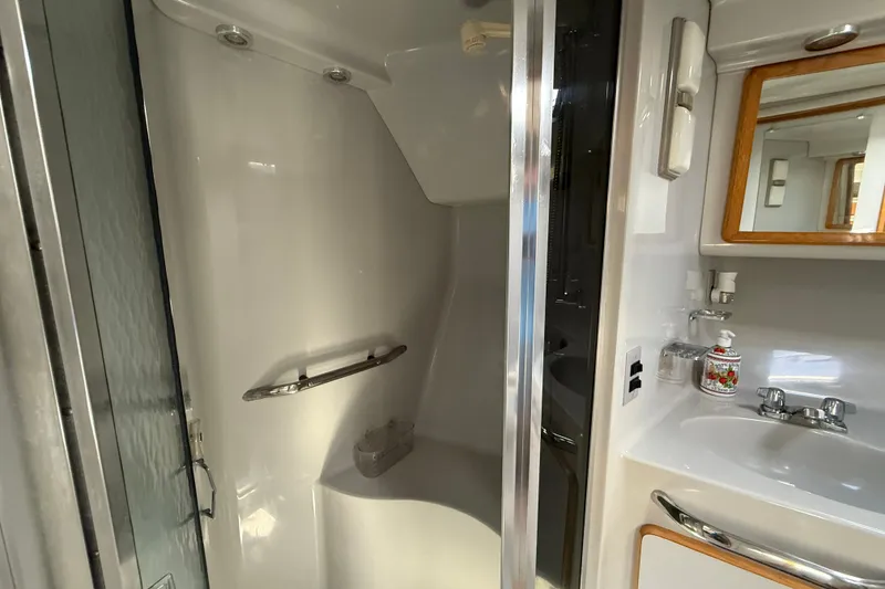 Slide: The Image of Bathroom interior of 1990 Sea Ray 420 Sundancer yacht, featuring shower and sink area. - 20