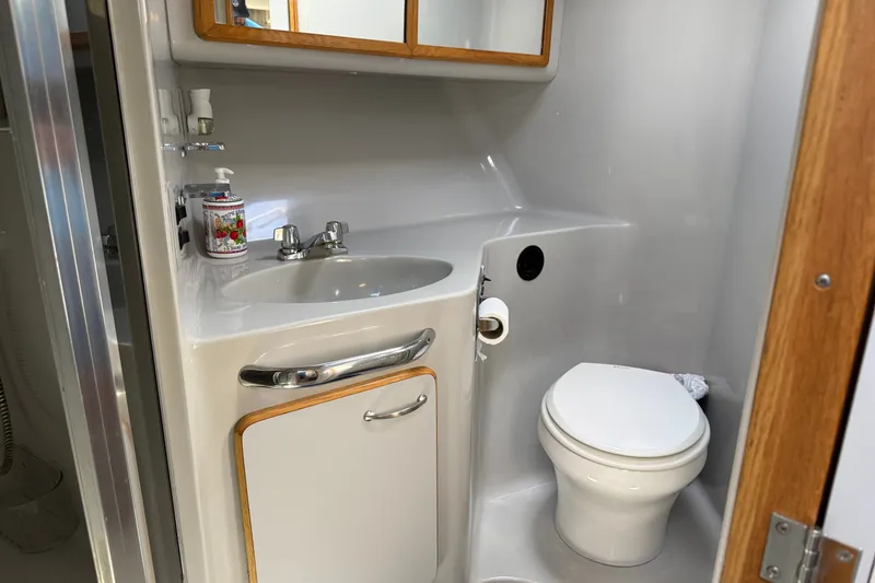 Slide: The Image of Bathroom interior of 1990 Sea Ray 420 Sundancer yacht with sink and toilet. - 19