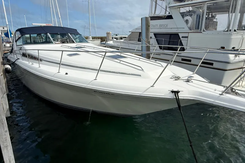 The Image of 1990 Sea Ray 420 Sundancer yacht docked at marina, side view. - 0