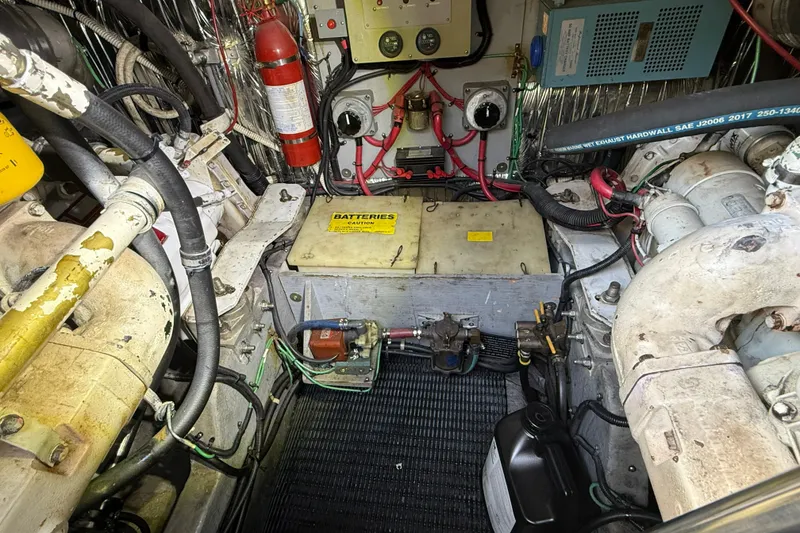 Slide: The Image of Engine room of a 1990 Sea Ray 420 Sundancer with batteries and fire extinguisher. - 29