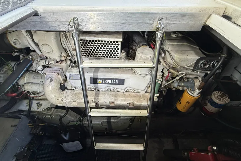 Slide: The Image of Engine compartment of a 1990 Sea Ray 420 Sundancer with Caterpillar engine and ladder access. - 27