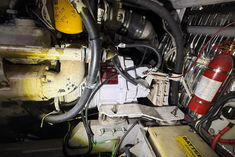 Slide: The Image of Engine compartment of a 1990 Sea Ray 420 Sundancer with visible components and fire extinguisher. - 30