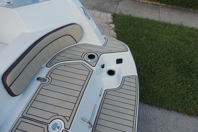 Slide: The Image of 2023 Yamaha Boats 222 FSH Sport E deck with cushioned seating and sleek design. - 6