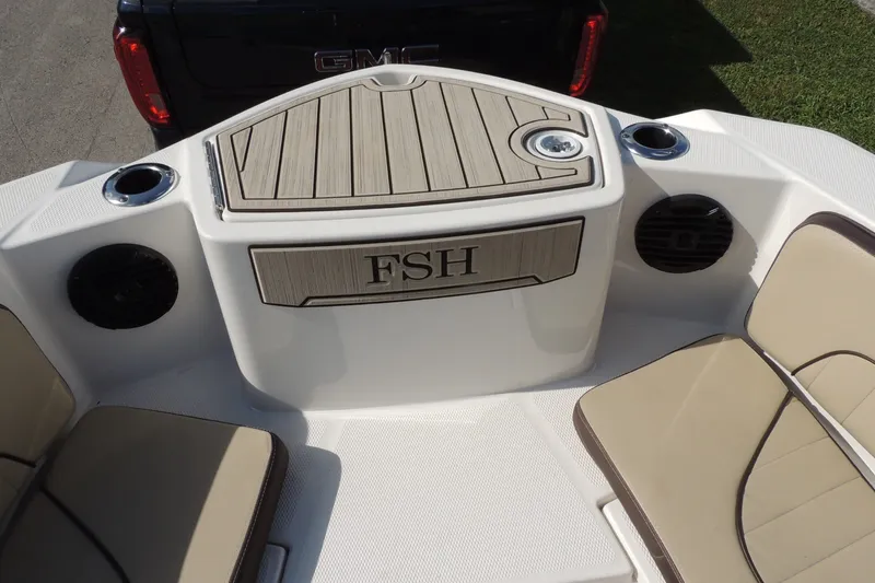 Slide: The Image of 2023 Yamaha Boats 222 FSH Sport E interior with seating and storage area. - 25