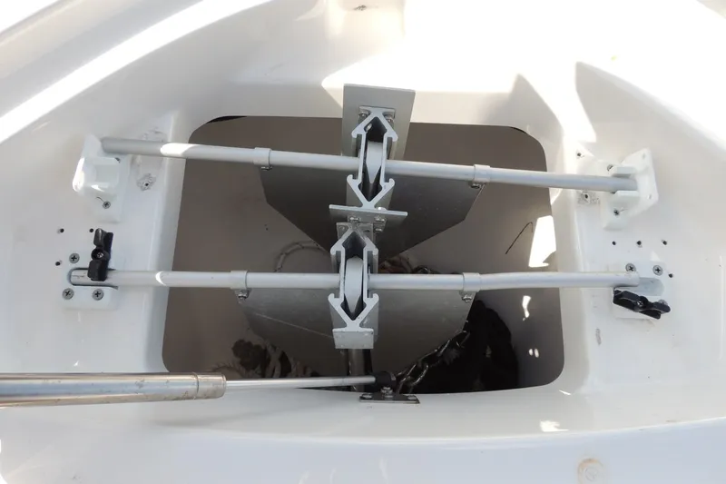 Slide: The Image of Anchor compartment of 2023 Yamaha Boats 222 FSH Sport E, showcasing storage and mechanism. - 21
