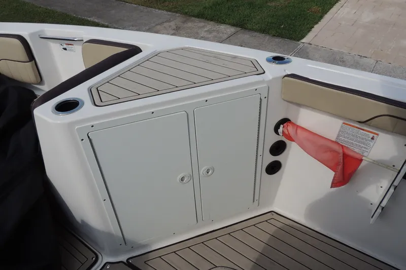Slide: The Image of 2023 Yamaha Boats 222 FSH Sport E interior with storage compartment and seating. - 18