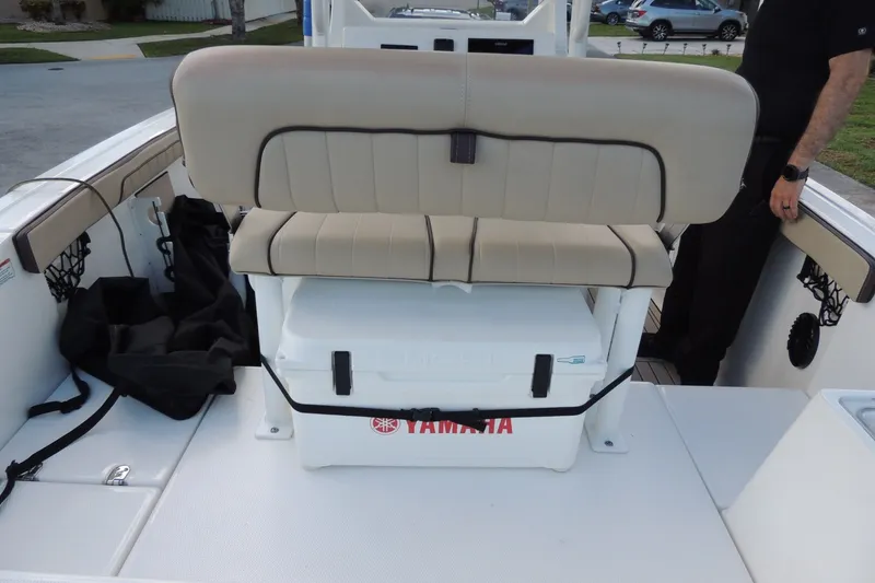 Slide: The Image of 2023 Yamaha Boats 222 FSH Sport E interior with seating and storage features. - 9