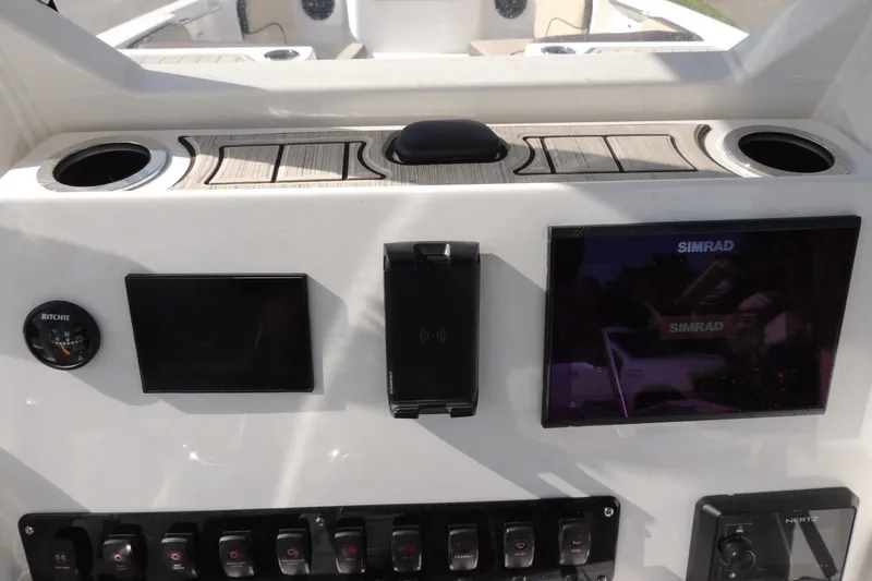Slide: The Image of 2023 Yamaha Boats 222 FSH Sport E dashboard with Simrad display and controls. - 23