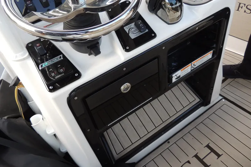 Slide: The Image of 2023 Yamaha Boats 222 FSH Sport E console with steering wheel and controls. - 11