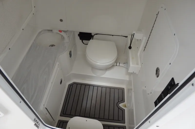 Slide: The Image of Interior of 2025 Sea Hunt Gamefish 28 boat bathroom with toilet and sink. - 25