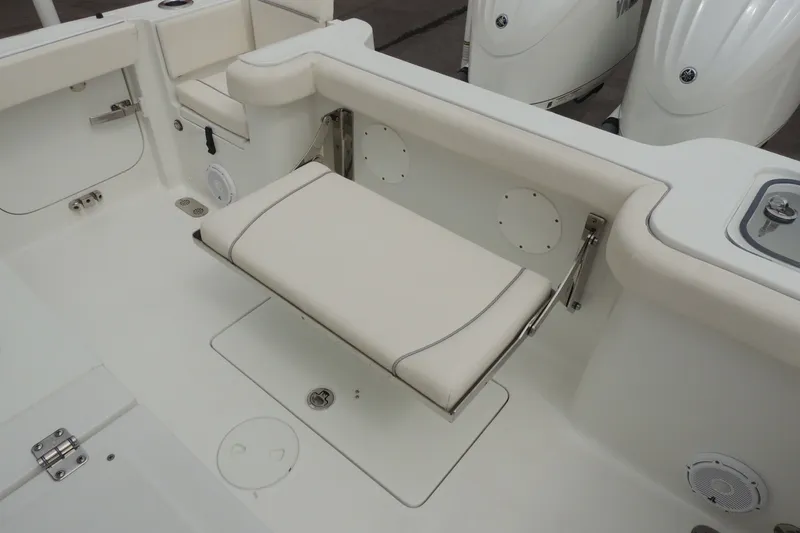 Slide: The Image of 2025 Sea Hunt Gamefish 28 boat interior with foldable seating and dual outboard motors. - 18