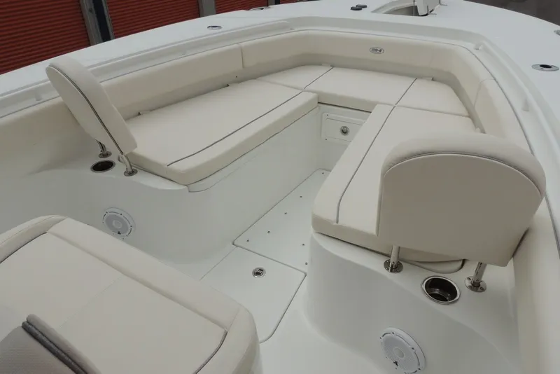 Slide: The Image of 2025 Sea Hunt Gamefish 28 boat interior with white cushioned seating and storage compartments. - 26