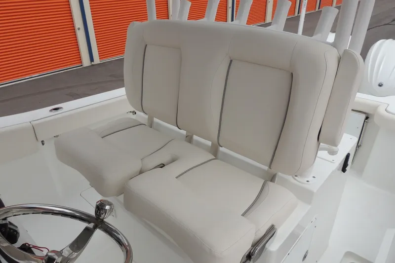 Slide: The Image of 2025 Sea Hunt Gamefish 28 boat interior with beige seating and steering wheel. - 21