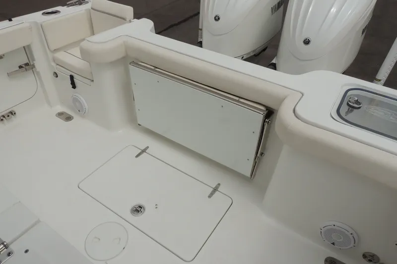 Slide: The Image of 2025 Sea Hunt Gamefish 28 boat interior with Yamaha engines, featuring storage and seating. - 17