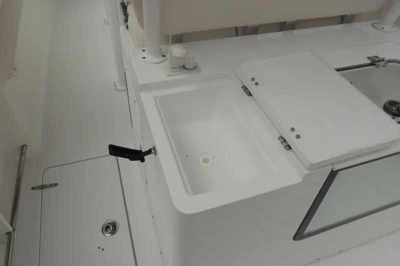 Slide: The Image of Interior view of a 2025 Sea Hunt Gamefish 28 boat, featuring a clean, white sink area. - 22