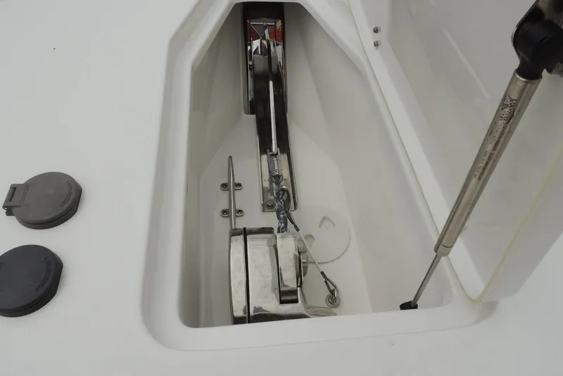 Slide: The Image of Anchor compartment of 2025 Sea Hunt Gamefish 28 boat, featuring stainless steel hardware. - 28