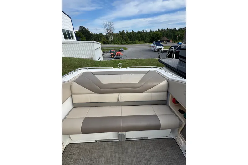 Slide: The Image of Interior view of a 1996 Cobalt 272 boat with beige seating and outdoor background. - 44