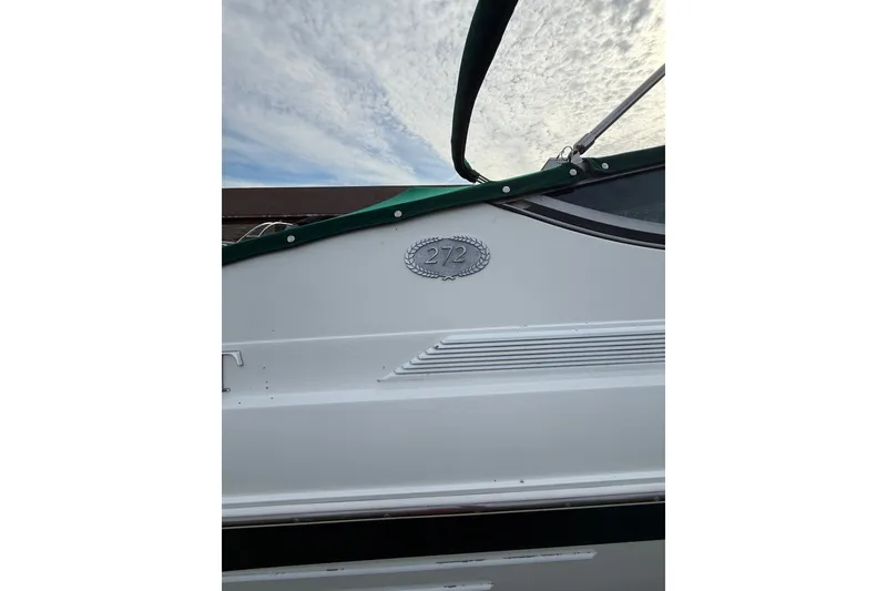 Slide: The Image of 1996 Cobalt 272 boat side view with green canopy and model emblem. - 40