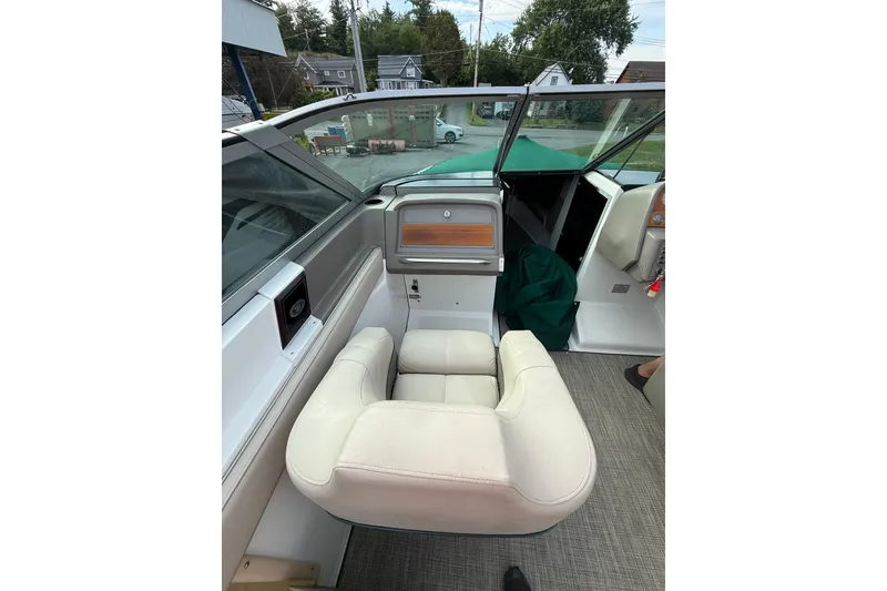 Slide: The Image of Interior of a 1996 Cobalt 272 boat featuring a white captain's chair and dashboard. - 16