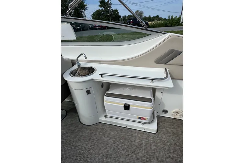 Slide: The Image of Interior of a 1996 Cobalt 272 boat featuring a sink and cooler setup. - 17