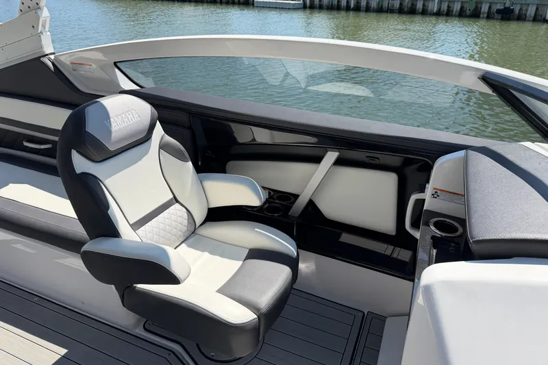 Slide: The Image of 2023 Yamaha Boats 275SE interior with luxurious seating and sleek design. - 17
