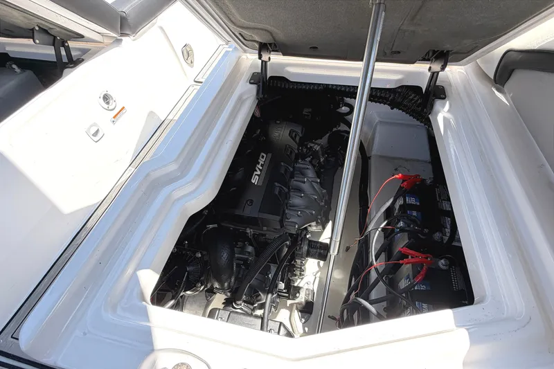 Slide: The Image of Engine compartment of 2023 Yamaha Boats 275SE, showcasing powerful SVHO engine and batteries. - 24