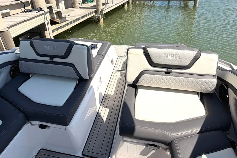 Slide: The Image of 2023 Yamaha Boats 275SE at dock, showcasing luxurious seating and waterfront view. - 23