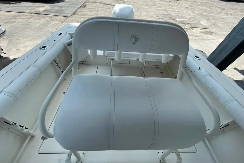 Slide: The Image of 2007 Edgewater 245CC boat interior with white seating and storage compartments. - 13