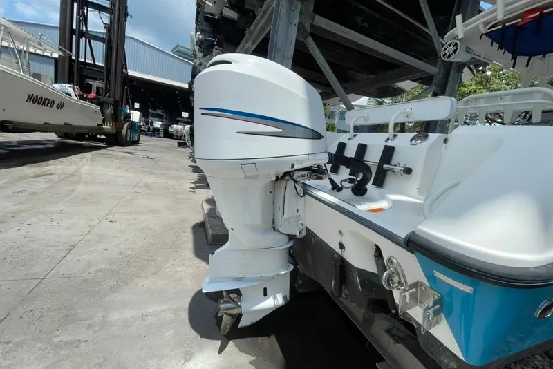 Slide: The Image of 2007 Edgewater 245CC boat with outboard motor in a marina storage area. - 26