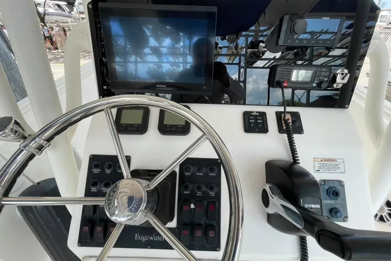 Slide: The Image of Helm of 2007 Edgewater 245CC boat with steering wheel and navigation equipment. - 15