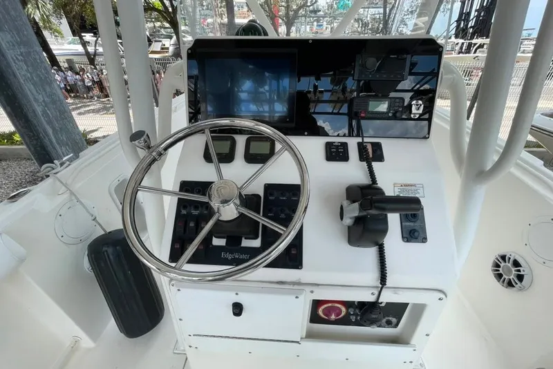 Slide: The Image of Edgewater 245CC 2007 boat console with steering wheel and navigation controls. - 14