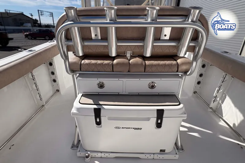 Slide: The Image of 2019 Sportsman Open 232 Center Console boat interior with rod holders and storage compartments. - 9