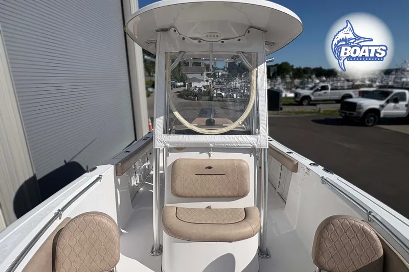Slide: The Image of 2019 Sportsman Open 232 Center Console boat with beige seating and clear enclosure. - 8