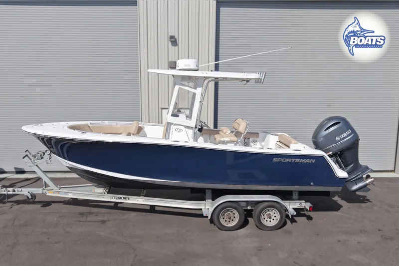 The Image of 2019 Sportsman Open 232 Center Console boat on trailer, featuring Yamaha engine. - 0
