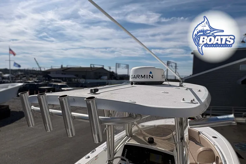 Slide: The Image of 2019 Sportsman Open 232 Center Console boat with Garmin radar, docked under a clear sky. - 5