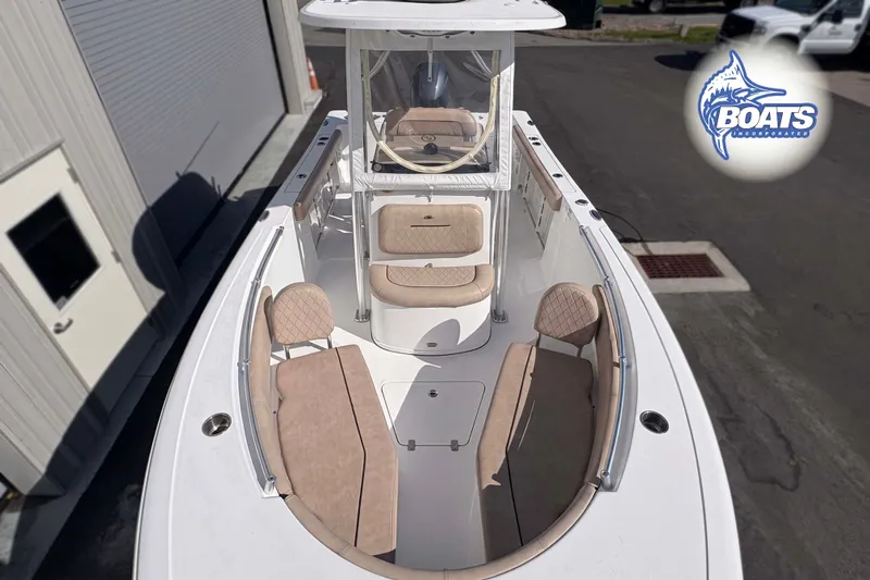 Slide: The Image of 2019 Sportsman Open 232 Center Console boat with beige seating and sleek design. - 6