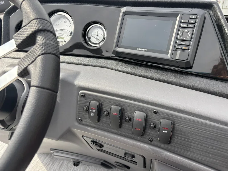 Slide: The Image of The image shows the dashboard of a Bennington 21 S1SB SPS boat with a Garmin display and several switches. - 22