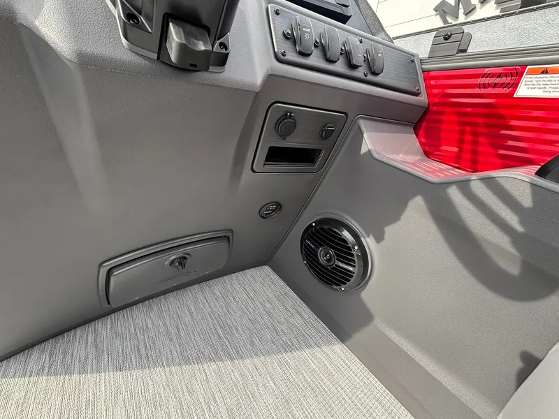 Slide: The Image of Close-up of the gray interior of a Bennington 21 S1SB SPS boat with speaker and controls. - 23