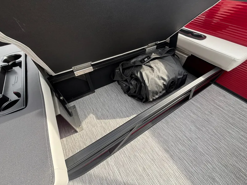 Slide: The Image of An open storage compartment on a boat with a black bag inside. - 25