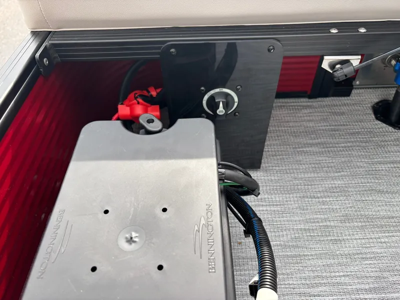 Slide: The Image of Close-up of a boat component with cables and a switch on a gray floor. - 28