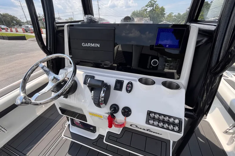 Slide: The Image of 2022 Tidewater 2500 Carolina Bay boat dashboard with Garmin navigation system. - 7