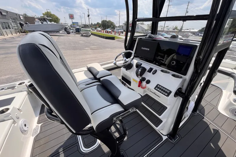 Slide: The Image of 2022 Tidewater 2500 Carolina Bay boat interior with Garmin navigation system and sleek seating. - 6