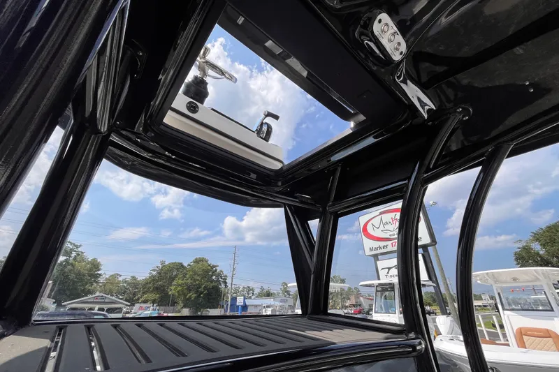 Slide: The Image of Interior view of 2022 Tidewater 2500 Carolina Bay boat with open roof hatch. - 17