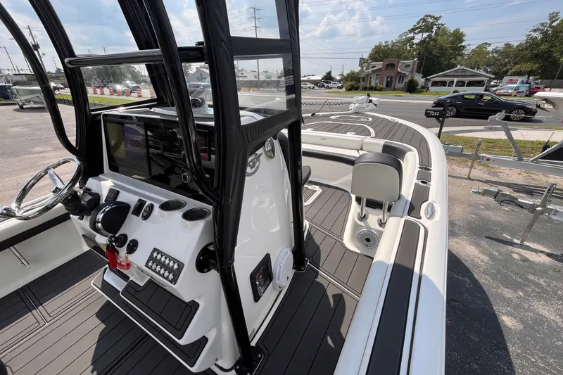 Slide: The Image of 2022 Tidewater 2500 Carolina Bay boat interior with modern console and seating. - 10