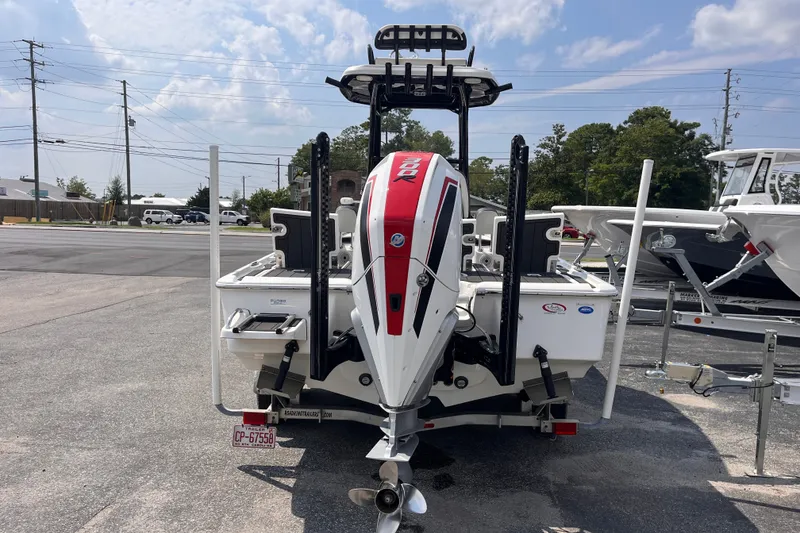 Slide: The Image of 2022 Tidewater 2500 Carolina Bay boat with powerful outboard motor, parked on a trailer. - 3