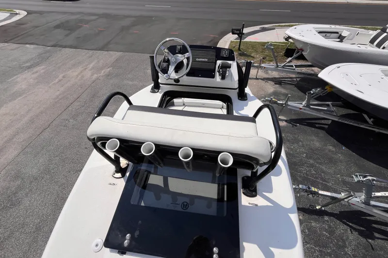 Slide: The Image of 2022 Tidewater 2500 Carolina Bay boat console with steering wheel and rod holders. - 19
