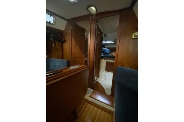 Slide: The Image of Interior of a 1992 Tartan 3100 with wood finish and blue upholstery. - 10