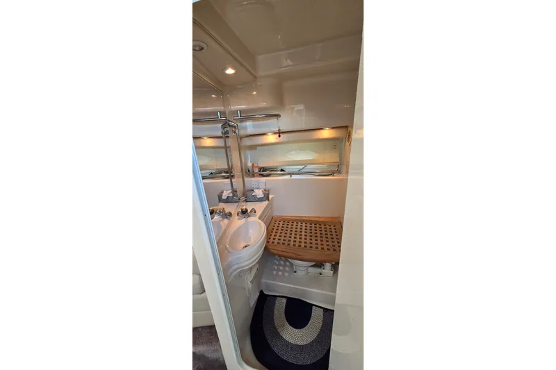 Slide: The Image of Bathroom interior of 2001 Monterey 322 Cruiser with sink, mirror, and wooden accents. - 26